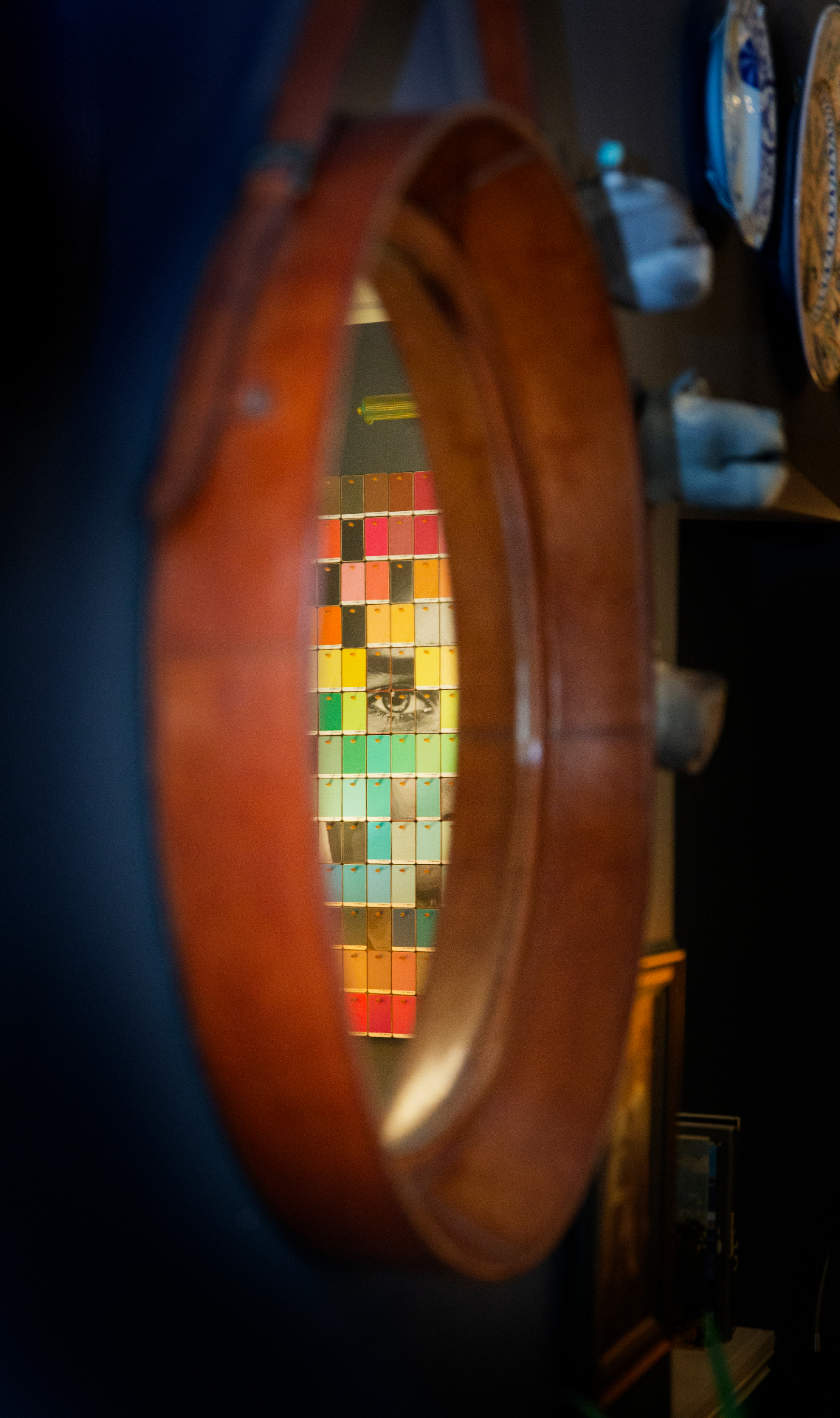 A mirror reflecting a mosaic of color and a single eye — Mirror Mirror